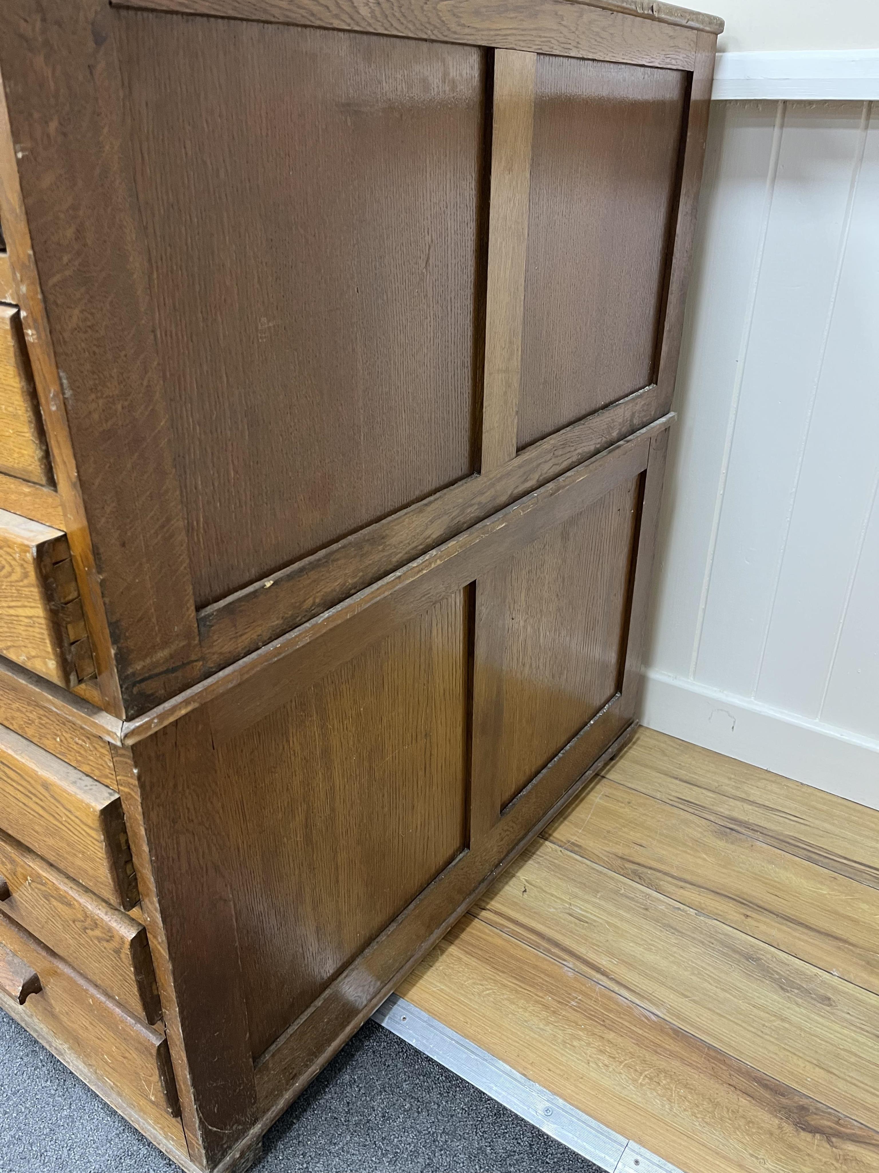 A 1930's light oak plan chest in two sections, width 113cm, depth 82cm, height 92cm